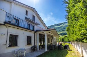 a large white house with a patio with tables and chairs at River Hotel in Castel di Sangro