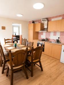 a kitchen with a wooden table and chairs in a kitchen at Puhkepesa 6 in Otepää