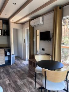 a living room with a table and chairs at Camping Familial Buffalo Hacienda in La Seyne-sur-Mer
