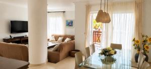 a living room with a couch and a table at Brisa Vacacional - Adults Only in Corralejo