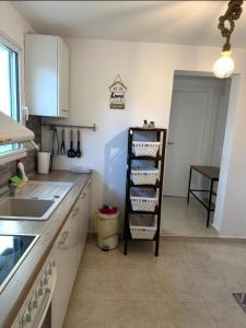 a kitchen with a shelf with dishes on it at Agathe Haus in Stavros
