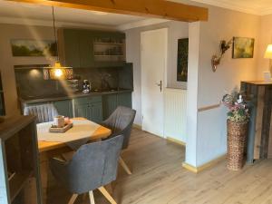 a kitchen and dining room with a table and chairs at Haus Louise in Reit im Winkl +18 photos