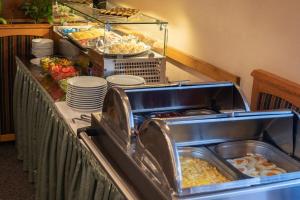 a buffet line with food and plates of food at Hotel u Crlíků in Tetčice