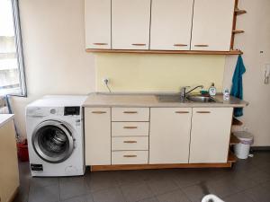 a kitchen with a washing machine and a sink at Mesta Room in Gotse Delchev