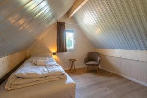 a small bedroom with a bed in a attic at EuroParcs Cadzand-Bad in Cadzand