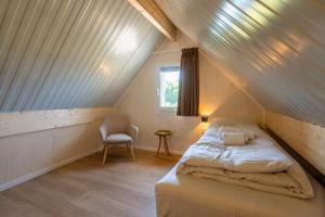 a small bedroom with a bed in a attic at EuroParcs Cadzand-Bad in Cadzand +46 photos