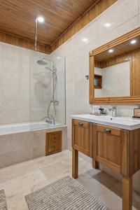 a bathroom with a sink and a shower and a tub at Pirin Golf Villa in Bansko +58 photos