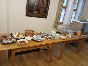 a wooden table with plates of food on it at Ursulinenkloster in Duderstadt +14 photos