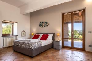 a bedroom with a bed and a sliding glass door at -Piscina privata- 10 posti letto, Wifi, AC, Garden in Ripatransone +59 photos