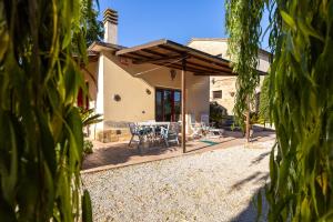 a view of a patio with a table and chairs at -Piscina privata- 10 posti letto, Wifi, AC, Garden in Ripatransone