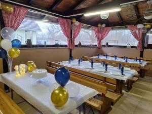a row of tables in a restaurant with balloons at Kuća za odmor San in Lonja