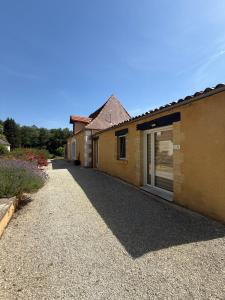 a house with a driveway next to a building at Les gîtes de la Joubertie in Salon +28 photos