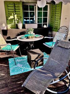 a patio with chairs and a table and a table and chairs at Zurich near the lake single room in historical house shared Bathroom in Kilchberg +12 photos