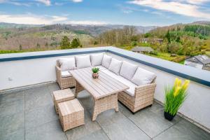 a patio with a table and chairs on a balcony at Immo-Vision - Penthouse Privat Wellness in Bergneustadt