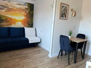 a living room with a couch and a table at Apartamenty Harnaś in Rytro