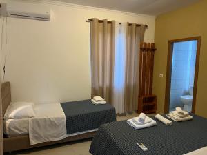 a room with two beds and a bathroom with a mirror at prekal park kamping in Shkodër