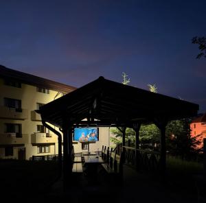 a large screen tv in a pavilion in front of a building at Ideal Predeal in Predeal
