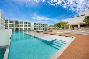 an empty swimming pool in front of a building at Patong Beach Hotel by See2Sea in Patong Beach +262 photos