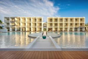 a hotel with a pool in front of a building at Patong Beach Hotel by See2Sea in Patong Beach