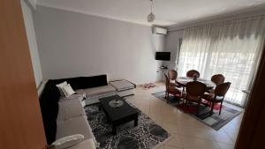 a living room with a couch and a table at Casa Vlora in Vlorë