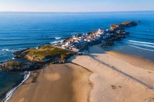 an aerial view of a beach next to the ocean at Kampaoh Peniche in Peniche
