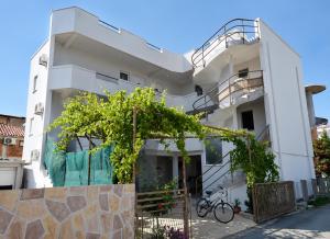 a white house with a bike parked in front of it at Vila Mia in Donji Štoj