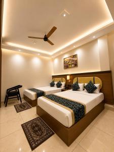 a bedroom with two beds and a ceiling at Hotel Shakuntla Palace - 400 Meters away from Vishnu Pad Temple 7 mins walk in Gaya +124 photos