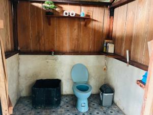 a bathroom with a blue toilet in a wooden wall at Nyanse Homestay - Raja Ampat in Besir +15 photos