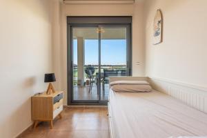 a bedroom with a bed and a balcony at Apartment In Golf Mar Resort in San Jorge +22 photos