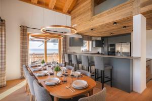 a dining room with a long wooden table and chairs at Guernerés & Spa by Alpine Resorts in Grimentz