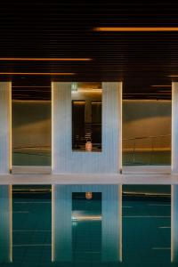 a building with a pool of water in front of it at St Elisabeth Hotel & Spa in Tromsø