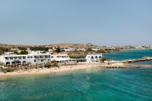 an aerial view of a beach with people in the water at Blue Waves Suites & Apartments - To Kyma in Drios