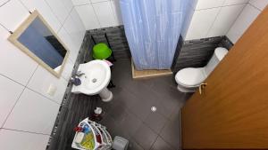 a small bathroom with a sink and a toilet at Casa Vlora in Vlorë +47 photos
