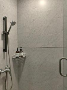 a bathroom with a shower with a glass door at High Clouds Hotel Apartment in Guangzhou +20 photos