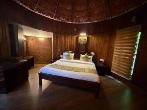 a bedroom with a large bed in a room at Sumeru valley vagamon in Idukki