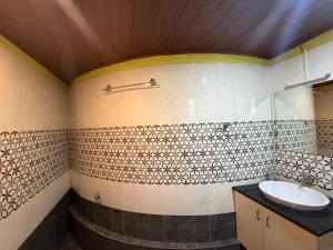 a bathroom with a sink and a mirror and a counter at Sumeru valley vagamon in Idukki