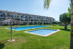 a resort with a swimming pool and a large building at Apartment In Golf Mar Resort in San Jorge