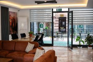 a living room with a couch and a table with chairs at Kriti Hotel Antalya in Antalya