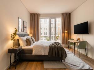 a bedroom with a bed and a desk and a window at Limehome Berlin Müllerstraße - Digital Access in Berlin