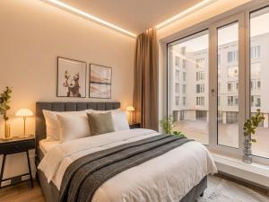 a bedroom with a bed and a large window at Limehome Berlin Müllerstraße - Digital Access in Berlin +75 photos
