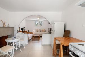 a kitchen and living room with a table and a refrigerator at Vasso Galati House in Vaia