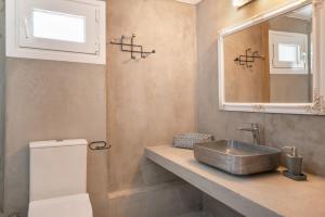 a bathroom with a sink and a mirror at Vasso Galati House in Vaia