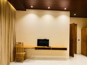 a living room with a television on a wall at Beach Escape in Arugam Bay