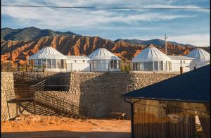 a group of buildings with mountains in the background at Casablanca Yurts in Kaji-Say +15 photos