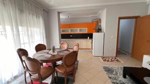 a kitchen and dining room with a table and chairs at Casa Vlora in Vlorë
