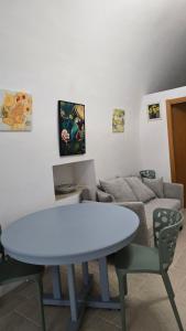 a living room with a white table and a couch at Casa Alba in Bernalda