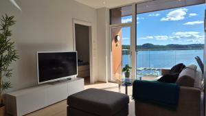 a living room with a flat screen tv and a couch at Seabreeze Suite in Arendal