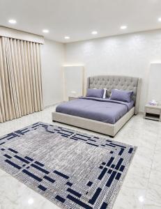a bedroom with a bed and a rug at Al Barari Farm & Resorts Al Ain in ‘Ayn al Fayḑah +75 photos