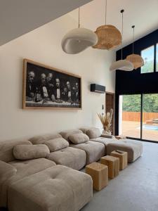 a living room with a large couch and a table at La Villa Andromède 10pers in Martillac