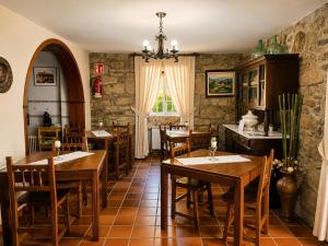 a restaurant with wooden tables and chairs and a window at Casa Ravel in Silleda